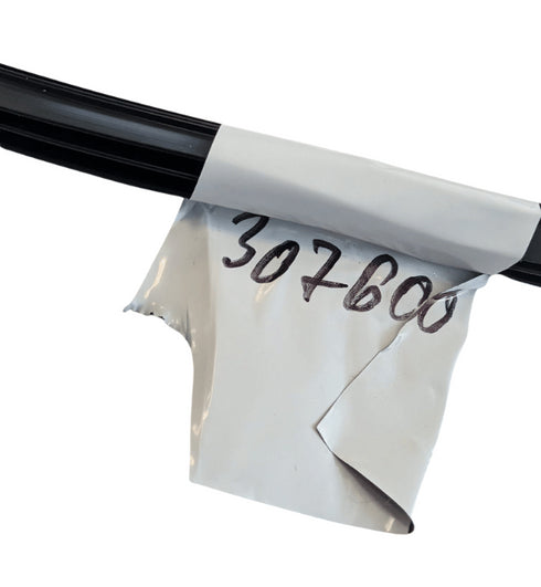 White plastic wrap with handwritten numbers on a black rod against a white background